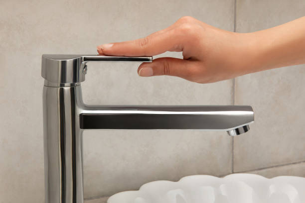 Woman hand on water tap Woman hand on water tap kalender stock pictures, royalty-free photos & images