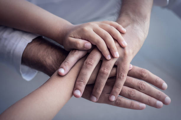 istock United hands of father and son. 988635920