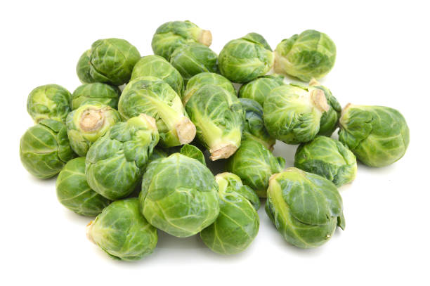 istock freshly brussel sprouts and some whole ones on a white background 988640580
