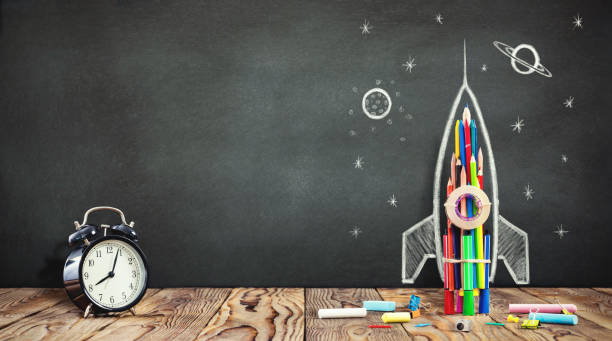 istock Back to School Concept with Hand Drawn Rocket on Blackboard 988641536