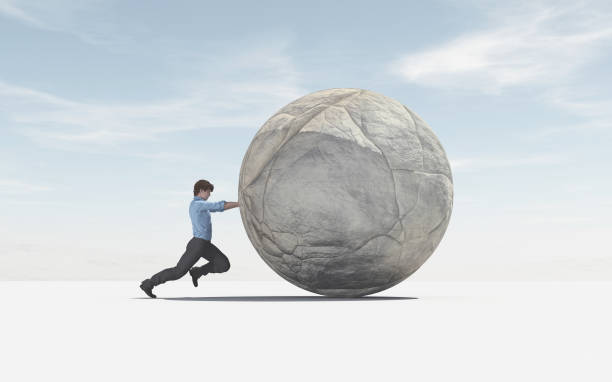istock Man pushing a big sphere to the top 988644300