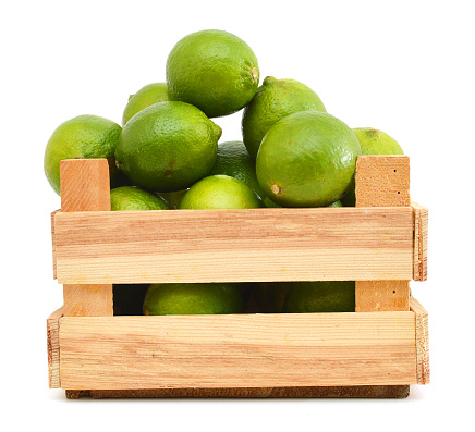 A green lemons on wooden box