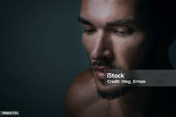 Close Up Portrait Of A Handsome Young Man With Brave Manly Face On Dark Background Caucasian Man Staring Serious Male Beauty Cosmetics Stock Photo - Download Image Now