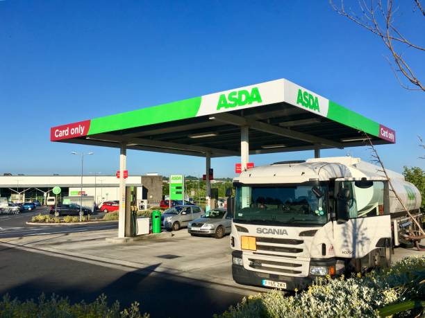 Asda Petrol Station - Delivery of Fuel Gorseinon, UK: June 27, 2018: A self-service petrol station at an Asda supermarket. A Scania delivery truck is off-loading its fuel to the underground storage tanks. Asda is owned by Wal-mart. asda photos stock pictures, royalty-free photos & images