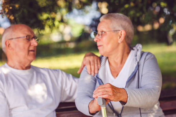 istock Romantic senior couple enjoying walk in park 988656680