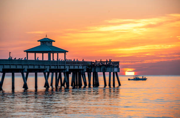 istock Deerfield Beach Florida Pier at Sunsrise with boat 988656888