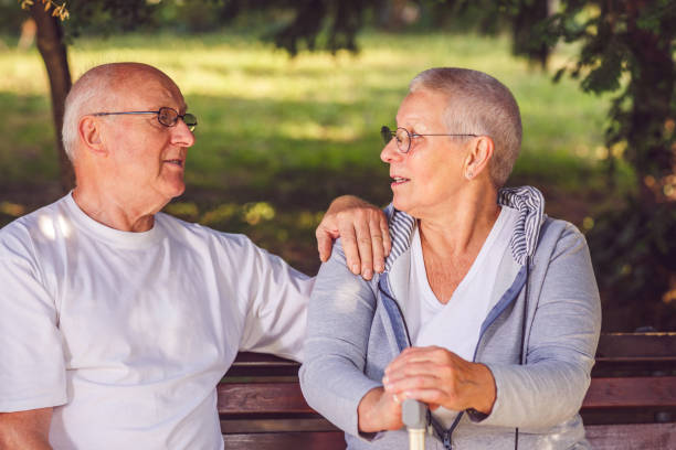 istock Romantic senior couple enjoying walk in park 988656942