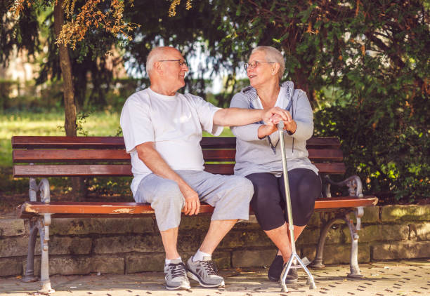 istock Romantic senior couple enjoying walk in park 988657084