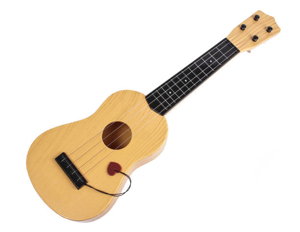 istock acoustic guitar with plectrum on white background 988658288