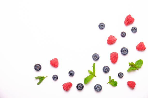 istock Bunch of fresh organic mixed berries, blueberry, raspberry & mint in seamless pattern, white background. Clean eating concept. Healthy vegan snack, raw diet. Close up, copy space, top view, flat lay. 988664378