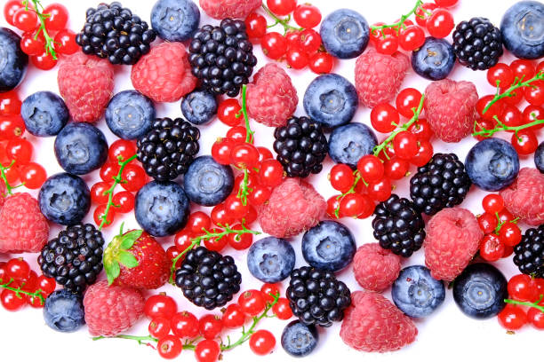 bunch of mixed berries in harvest pile on white background. colorful composition with fresh organic strawberry, blueberry, blackberry & redcurrant. clean eating concept. close up, copy space, top view - blackberry currant strawberry antioxidant imagens e fotografias de stock