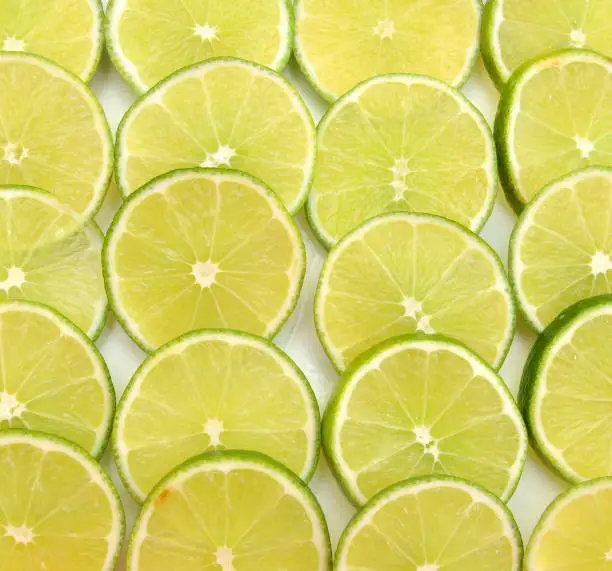 Green background with citrus-fruit of lime slices