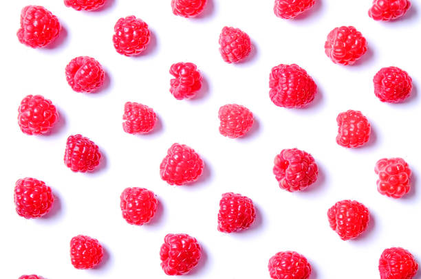 istock Bunch of fresh organic raspberry berries in seamless ornament pattern, white background. Clean eating concept. Healthy nutritious vegan snack, tasty raw diet. Close up, copy space, top view, flat lay. 988664924