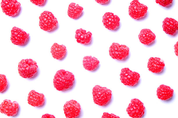 istock Bunch of fresh organic raspberry berries in seamless ornament pattern, white background. Clean eating concept. Healthy nutritious vegan snack, tasty raw diet. Close up, copy space, top view, flat lay. 988664956