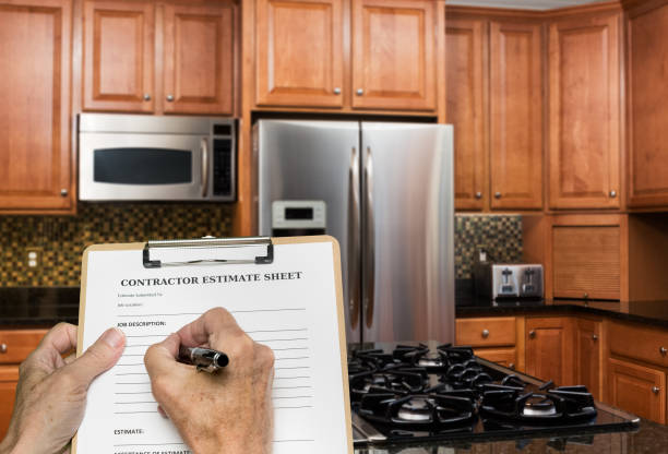 istock Contractor fills out estimate for modern kitchen 988669588