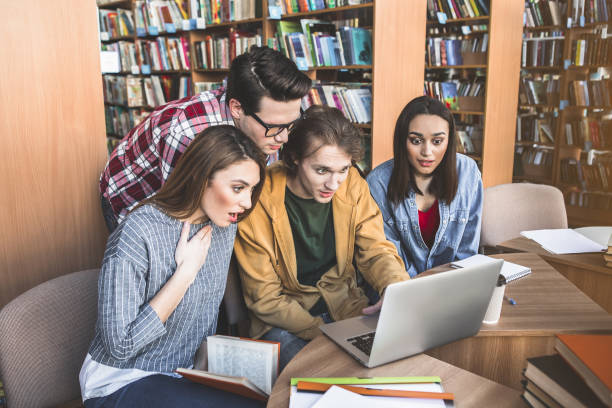 istock Astonished students watching at laptop 988670216