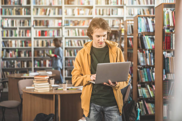 istock Beaming male looking at laptop 988671610