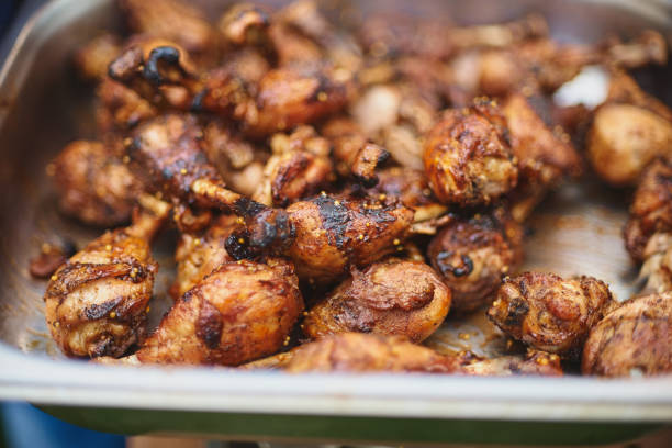 istock Marinated Chicken Legs Fried On The Hot Flaming BBQ Grill 988671632