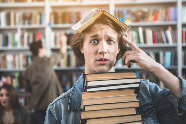 istock Unhappy male with volume on head 988676596