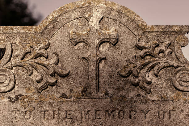 istock Genealogy and ancestry. Old graveyard headstone 'to the memory of'. 988699334