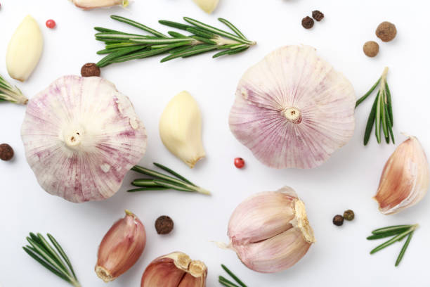 istock Garlic with rosemary, black pepper isolated on white background. Isolated garlic 988701978