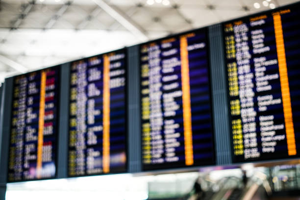 istock blurred display flight board backgrounds at airport. 988703356