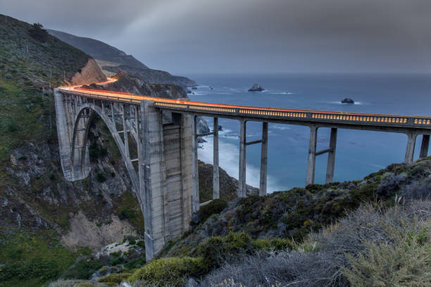 istock Car trails illuminating Bixby Bridge. 988709078