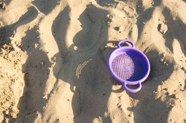 Colorful children's sand play equipment on the beach