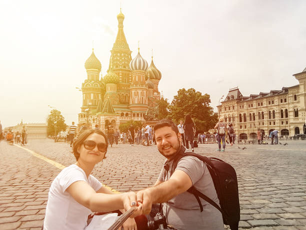istock Young couple taking selfie with Saint Basil cathedral 988733368