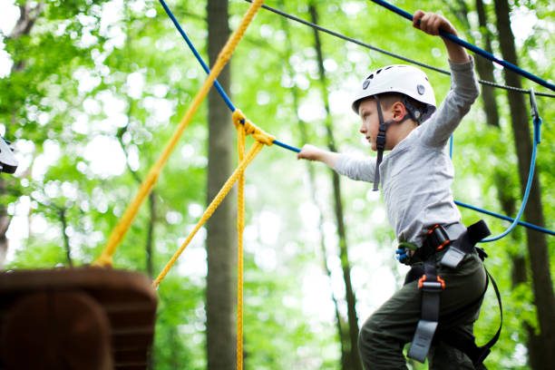 istock The little boy climbing in the rope park 988735364