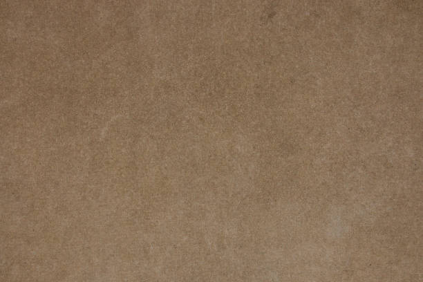 istock Brown concrete wall with fine grain texture. Photo of vintage plain background. Horizontal orientation 988754480