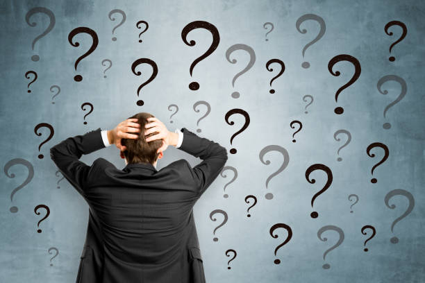 istock Worried businessman with questions 988754634