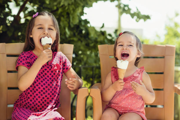 istock Children Enjoying Eating Ice Cream Outdoors in Summer 988757062
