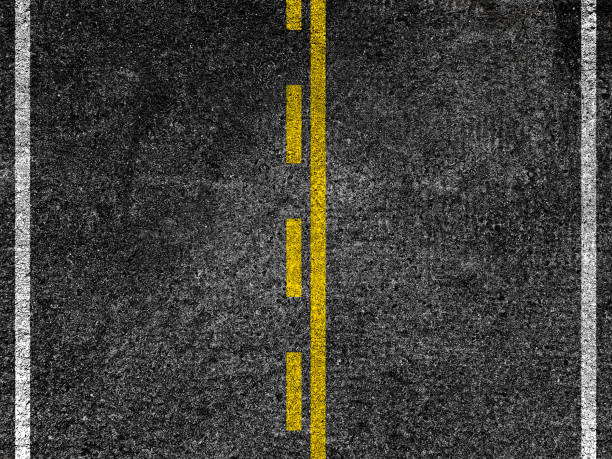 istock Asphalt road with dividing yellow lines. 988792836