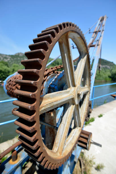istock Old crane on the dock, to pull the boat to the shore 988798494