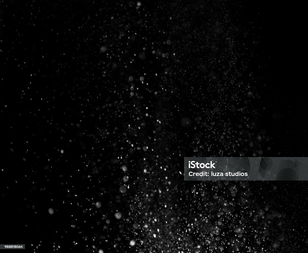 Dust Particles on black background Dust particles in motion against a black background. Shot in a studio. Particle Stock Photo
