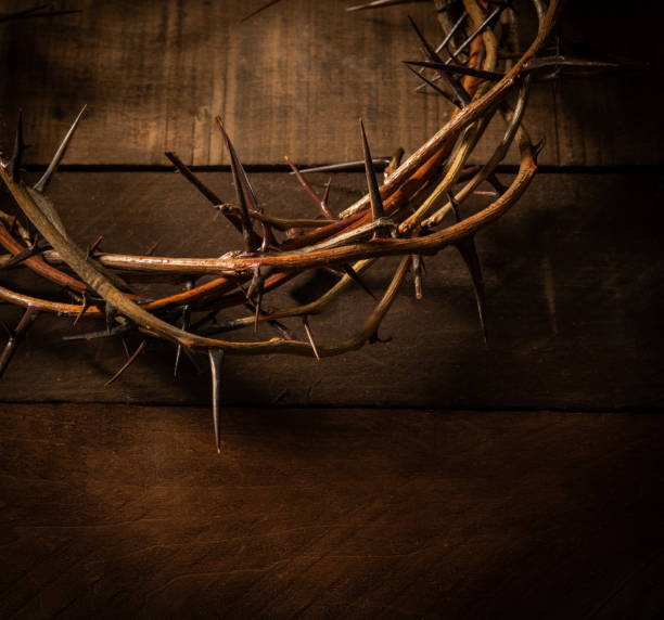 istock A crown of thorns on a wooden background. Easter Theme 988819020
