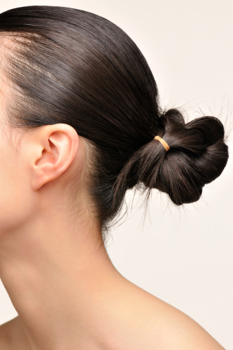 Japanese woman's profile with her hair tied