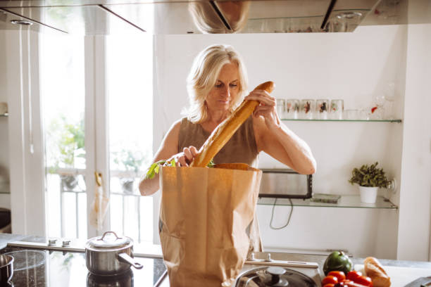 istock woman unpacking the vegetables 988833452