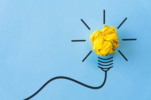 istock Inspiration and great idea concept. light bulb with crumpled yellow paper on blue background. 988895880