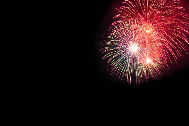 istock Abstract beautiful colorful fireworks display for celebration on black background with free space for text. New year holiday concept. 988895904