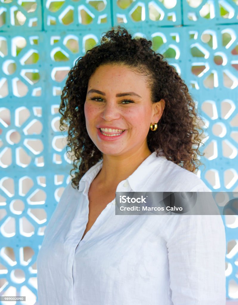 young beautiful and happy latin afro mixed woman on her 30s smiling cheerful and posing fresh outdoors isolated on beautiful background in happiness and success concept 30-39 Years Stock Photo