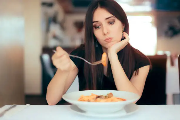 Depressed lonely woman suffering from appetite loss