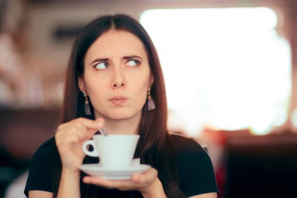 istock Surprised Woman Drinking Coffee in a Restaurant 989020102