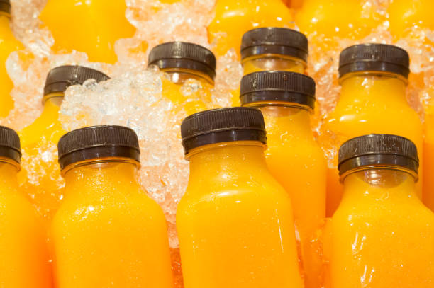 istock Orange juice in bottles with black cap 989060814