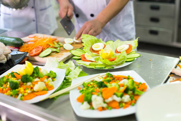 istock Chef cutting vegetables in asian restaurant 989107868