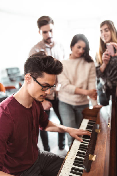 istock friends playing piano all together 989111258