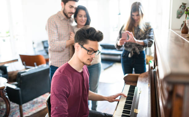 istock friends playing piano all together 989111348