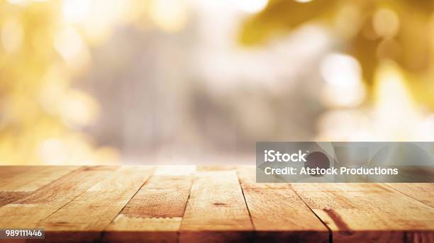 Wood Table Top On Blur Abstract Natural Foliage Bokeh Background Vintage Tone Stock Photo - Download Image Now