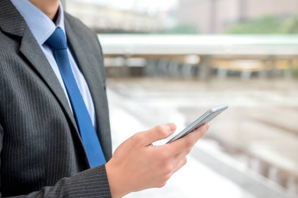 istock Businessman using smartphone searching for online information 989112676